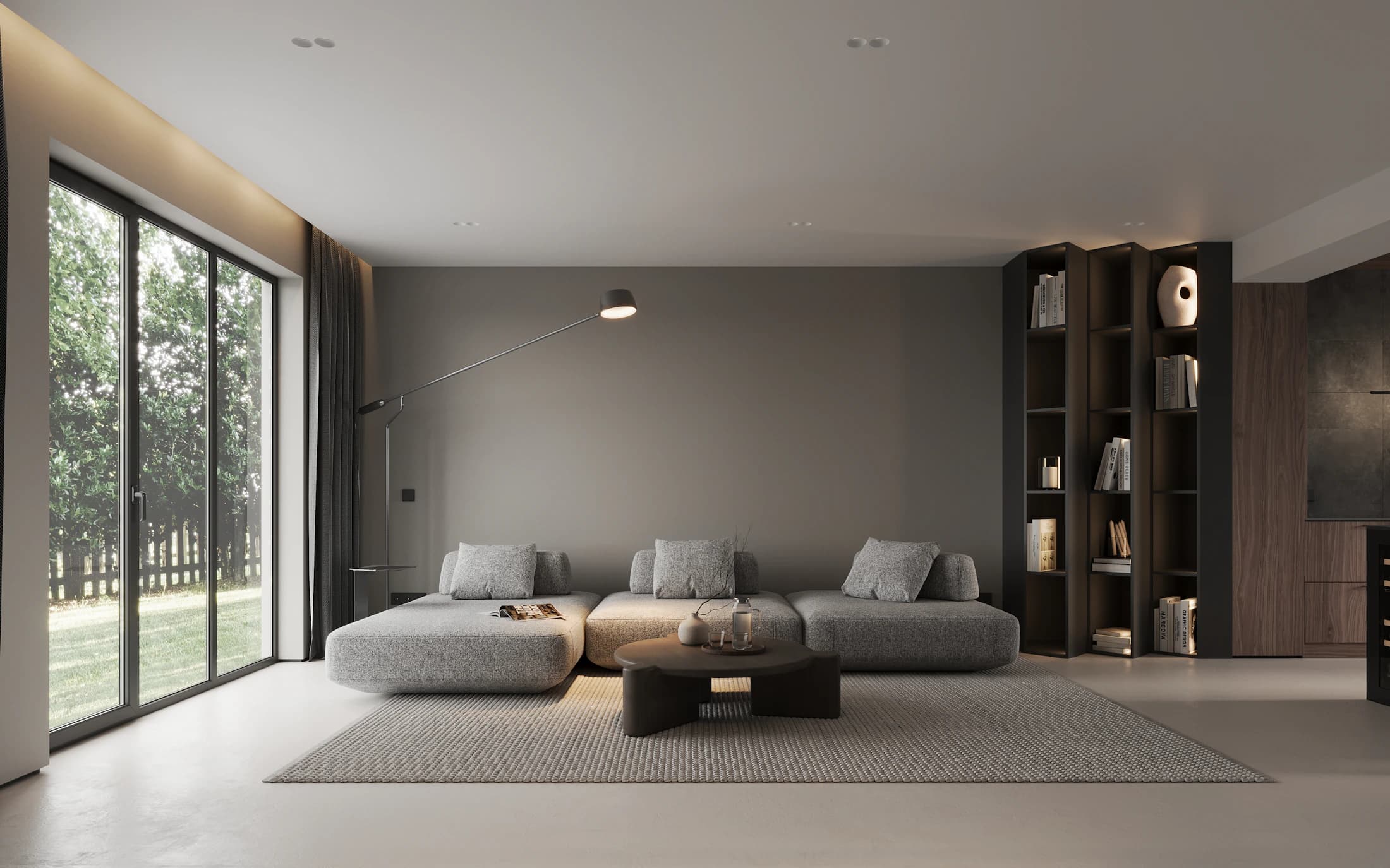 Quiet grey living room with low seating, dark timber joinery and a full-height window onto trees